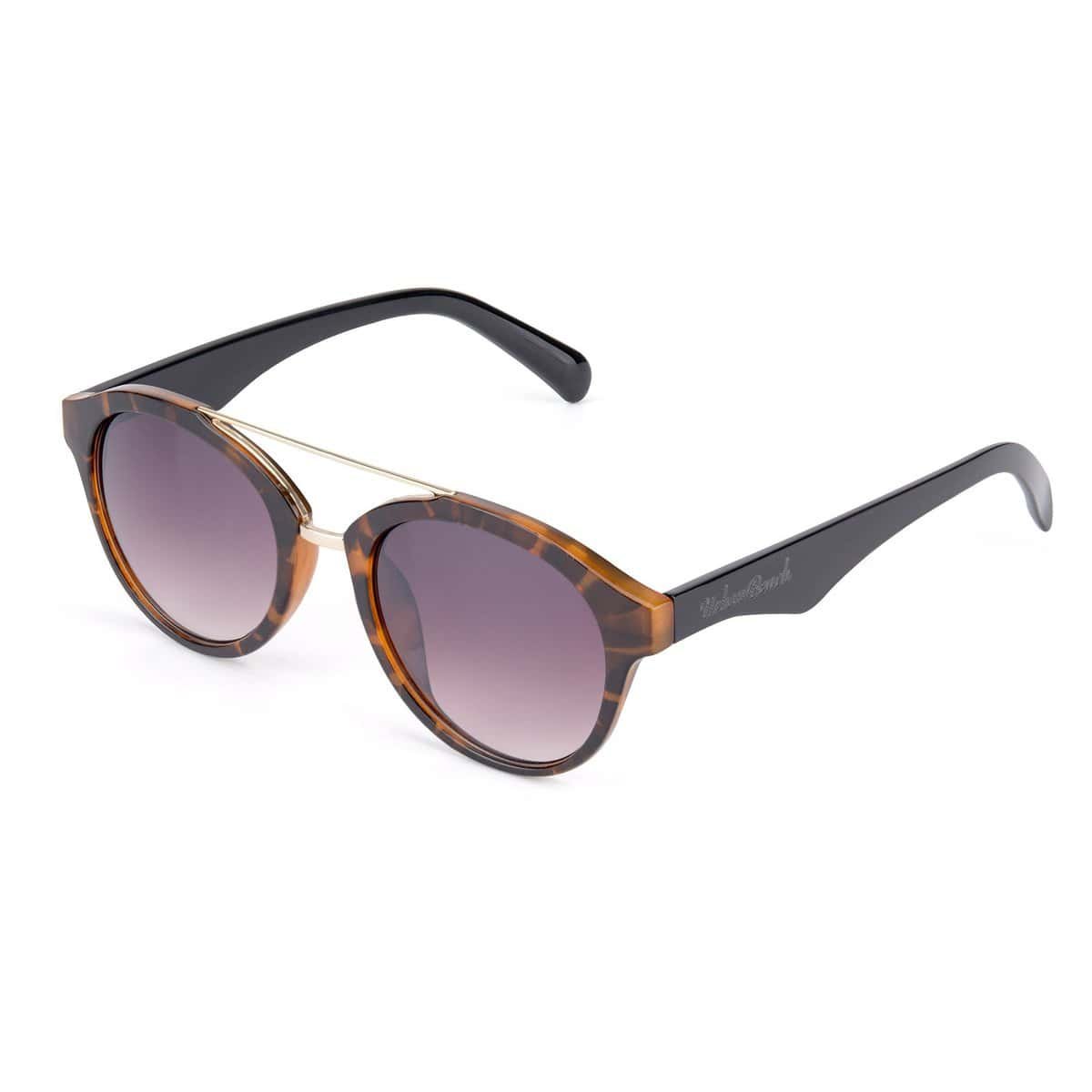 Ronde zonnebril met tortoise frame en gradient grijze glazen.