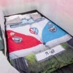 Skateboard and car print bedding with car lights and number plate design, suitable for outdoor rooms and play corners.